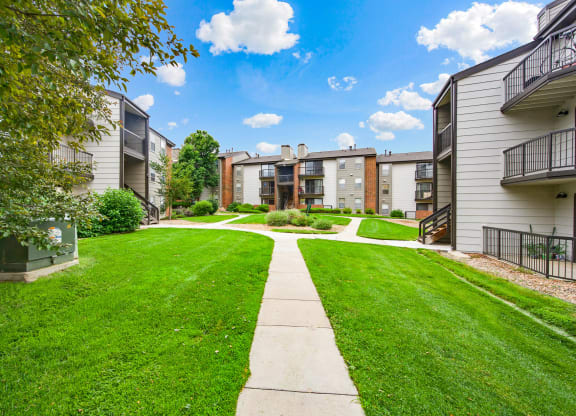 Beautiful community walkways between apartment buildings at Greensview Apartments in Aurora, CO