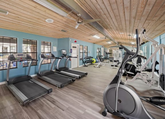 a gym with treadmills and other exercise equipment