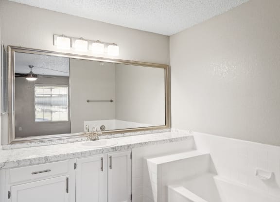 a bathroom with a bathtub and a sink