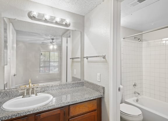 a bathroom with a sink toilet and tub