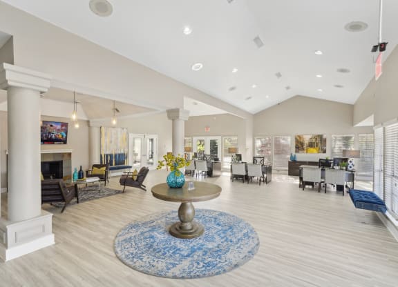 Interior of leasing office  with vaulted ceiling, office desks, and seating at Davenport Apartments in Dallas, TX