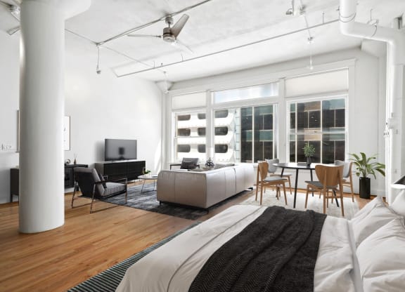 Mid Elm Lofts bedroom and living area with a large window