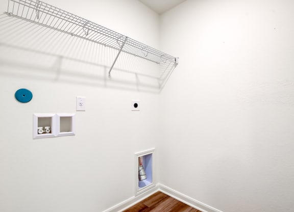 the laundry room with a closet and a shelf on the wall
