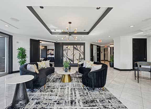 Resident lounge with two black couches at Dominion Post Oak apartments in Houston, TX