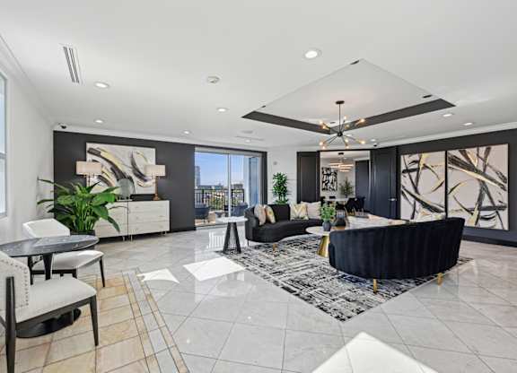 A spacious living room with a black and white color scheme.