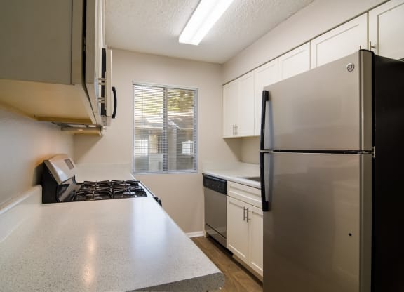 kitchen with marble countertop and a fridge at Dunwoody Pointe in Sandy Springs, GA