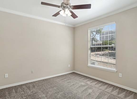 Edinburgh bedroom with a ceiling fan and a window at Encore at Buckingham Apartments in Richardson, TX