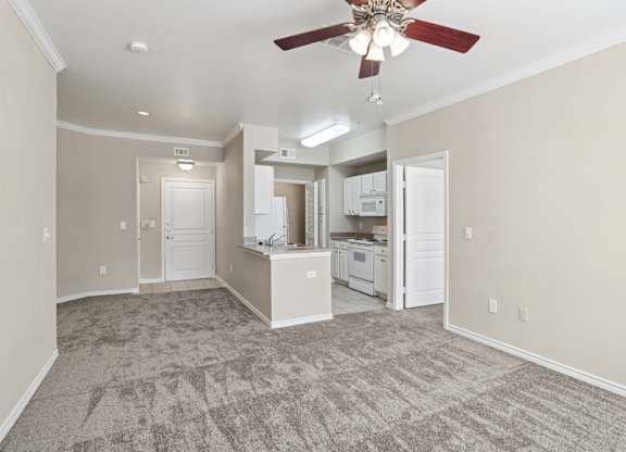 Edinburgh living room with carpet and a ceiling fan at Encore at Buckingham Apartments in Richardson, TX