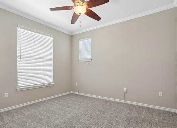 Kenzington bedroom with carpet and a ceiling fan at Encore at Buckingham Apartments in Richardson, TX