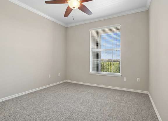 Kenzington bedroom with a carpet and ceiling fan at Encore at Buckingham Apartments in Richardson, TX