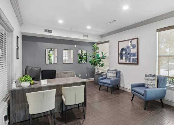 A leasing office with a desk and chairs at Encore at Buckingham Apartments in Richardson, TX