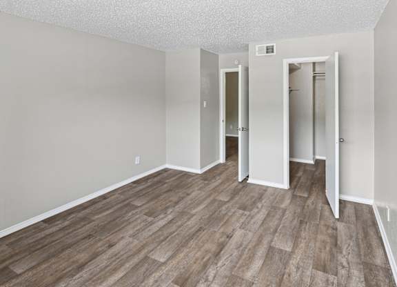 A room with wood flooring and white walls.