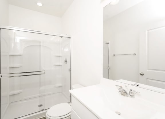 a bathroom with a sink toilet and shower