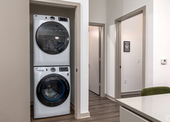 Stackable front loading washer and dryer in the apartment at Era apartments in Denton, TX