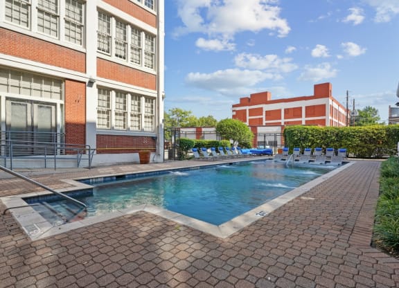 a swimming pool with a building in the background