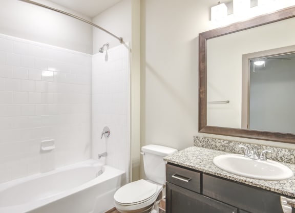 a bathroom with a sink toilet and a bath tub
