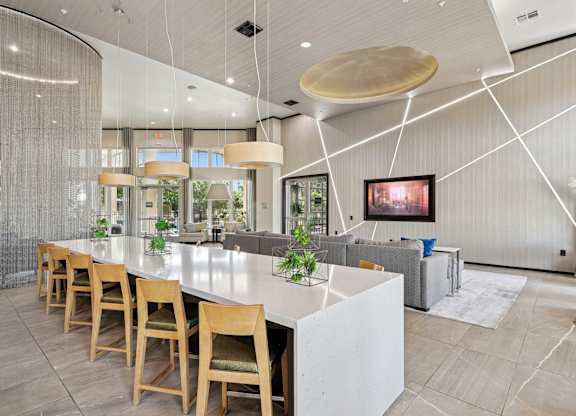 Clubhouse kitchen with island and a couch at GreenVue apartments in Richardson, TX