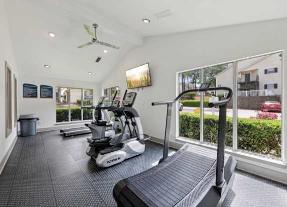 A fitness center with treadmills and ellipticals at Gwinnett Square Apartments in Duluth, GA