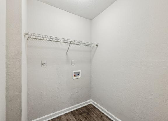A closet with a metal shelf and clothes rod at Gwinnett Square Apartments in Duluth, GA