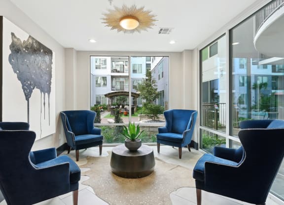 Indoor seating by large windows at Harlow River Oaks in Houston, TX