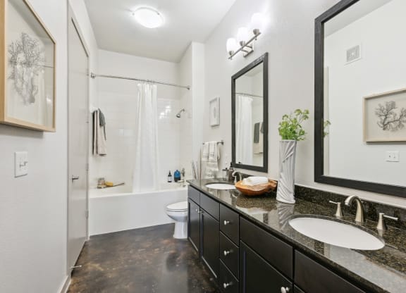 Model bathroom with two sinks and a shower at Harlow River Oaks in Houston, TX