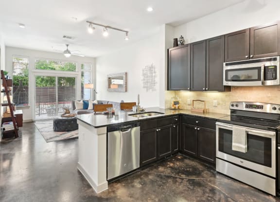 Model kitchen with stainless steel appliances at Harlow River Oaks in Houston, TX