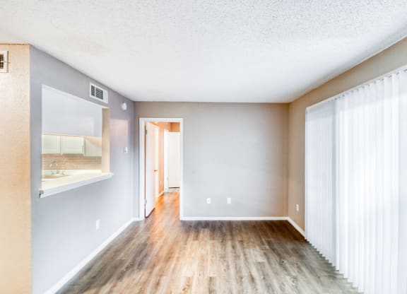 Unfurnished apartment living room with sliding door to patio/balcony at Hillside Creek Apartments in Austin, TX