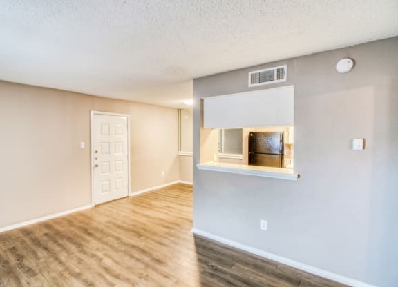 Unfurnished apartment living room looking at kitchen counter at Hillside Creek Apartments in Austin, TX