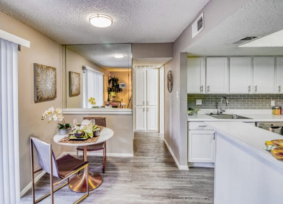Model home dining area with table at Hillside Creek Apartments in Austin, TX