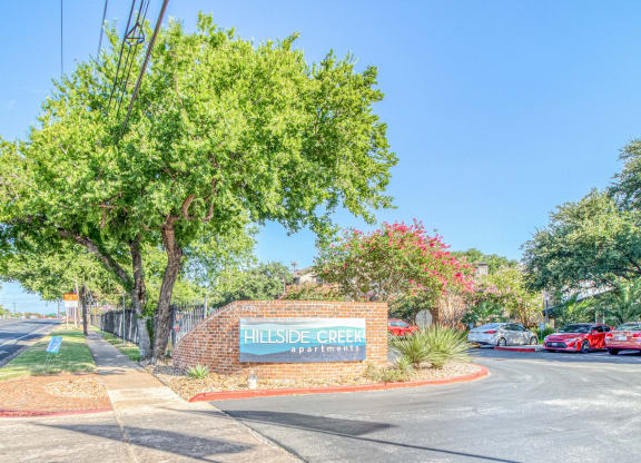 Property signage on bricks at Hillside Creek Apartments in Austin, TX