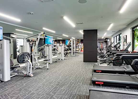 Our state-of-the-art fitness center with treadmills, free weights, and exercise machines at Hollywood Heights on the Boulevard Luxury Apartments in Hollywood, FL