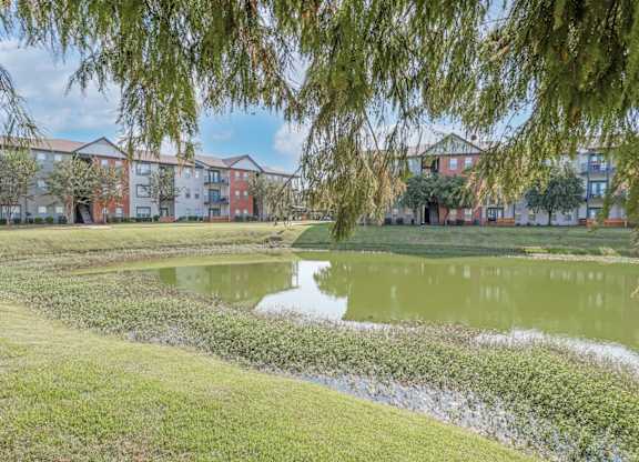 A pond in front of apartment buildings at Ultris Island Park in Shreveport, LA