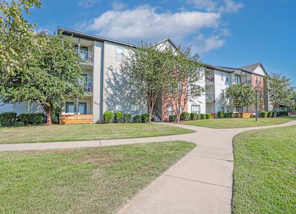 Apartment complex with a walkway in front at Ultris Island Park in Shreveport, LA
