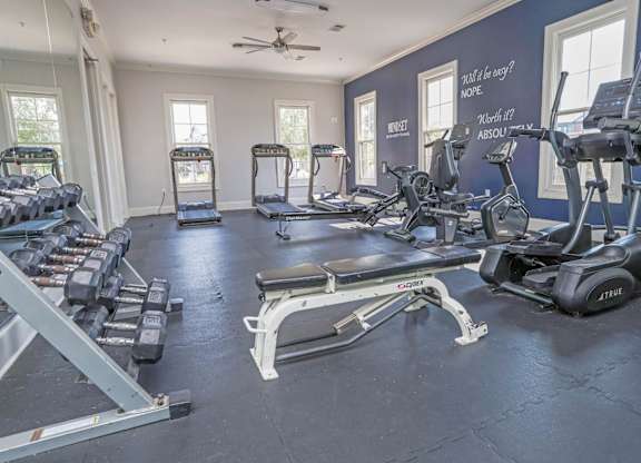A spacious gym with a variety of equipment including treadmills, elliptical machines, and dumbbells at Ultris Island Park in Shreveport, LA