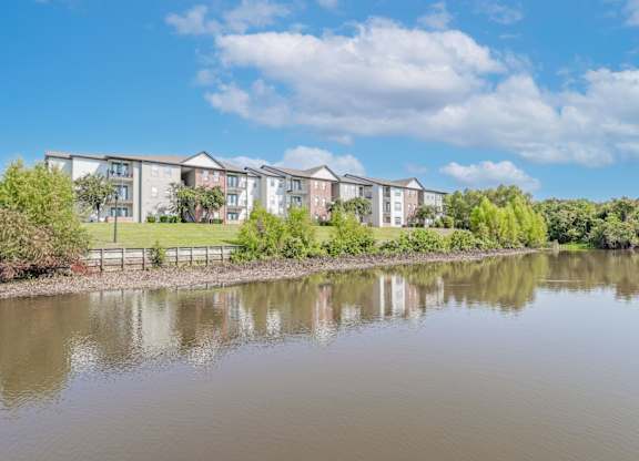 Apartments with a pond in front at Ultris Island Park in Shreveport, LA