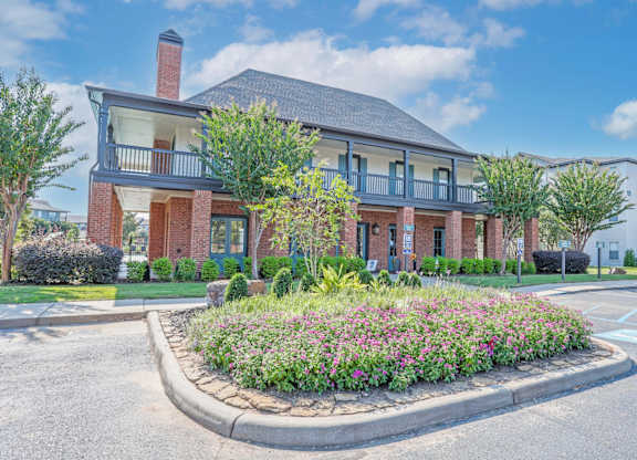 Leasing office with a flower bed in front of it at Ultris Island Park in Shreveport, LA
