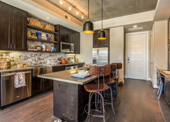 Rustic-modern interior of large kitchen setup with island at The Case Building in Dallas, TX