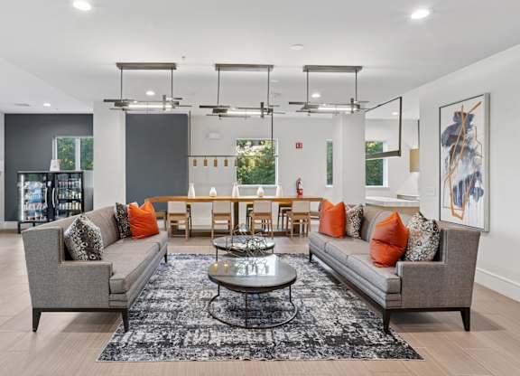 An entertainment lounge with grey sofas, a coffee table, and a gray rug at Knox Heights Apartments in Dallas, TX