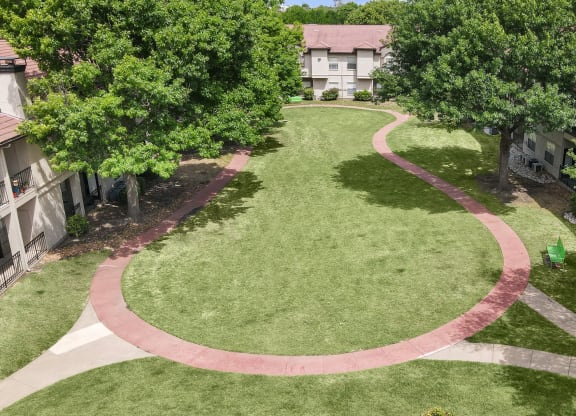 an aerial view of a grassy area with a circular walkway
