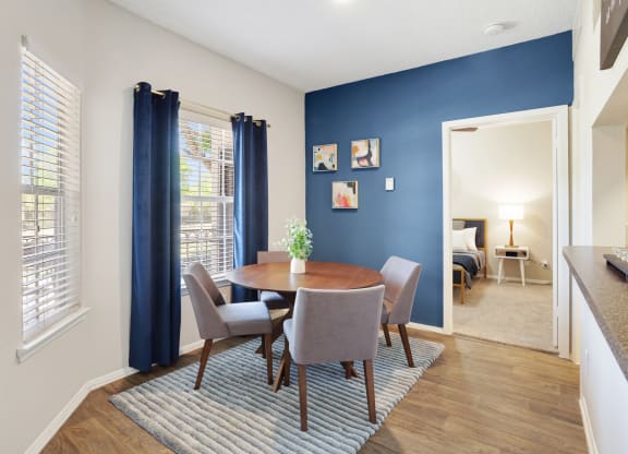 a dining room with a table and chairs
