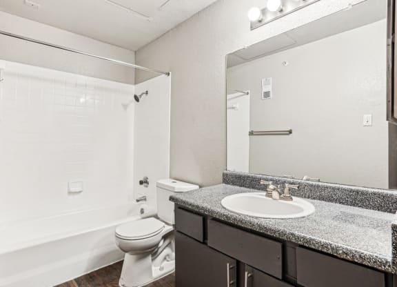 Well-appointed bathroom with shower/tub combo at Laurels of Sendera apartments in Arlington, TX