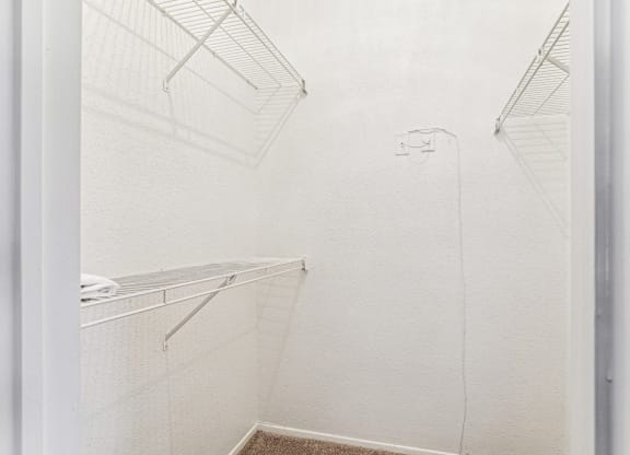 Walk-in closet with ample storage space at Laurels of Sendera apartments in Arlington, TX