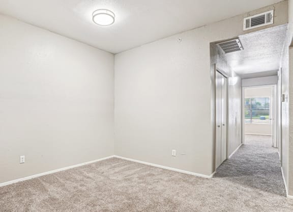 Large living room with an empty space for multiple usage at Laurels of Sendera apartments in Arlington, TX