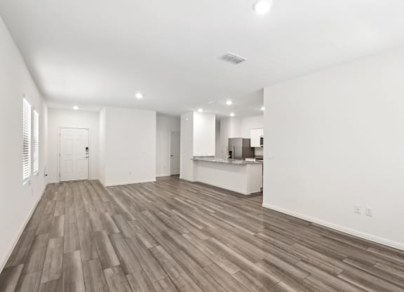 the living room and kitchen with hardwood floor