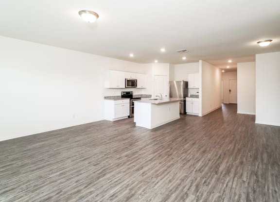 a spacious kitchen and living room area