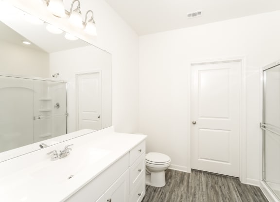 Magnolia master bathroom with stand-up shower, white counters and cabinets, at Beacon at Ashley River Landing in Summerville, SC