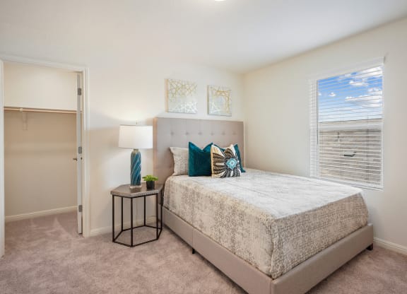 Maple model bedroom with a bed and a window at Beacon at Ashley River Landing in Summerville, SC