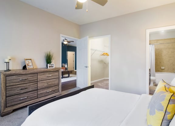 a bedroom with a bed and a dresser in a room