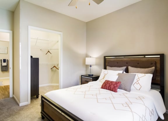 a bedroom with a large bed and a closet