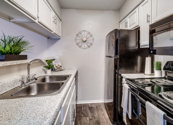 Model Kitchen with Upgraded Black Appliances at The Park on Preston in Dallas, Texas, TX